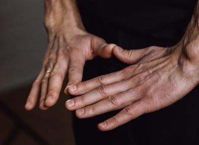 Close-up shot of hands and feet placement during a yoga pose.